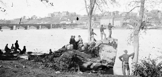 Union Soldiers look across the Potomac River to Georgetown, with the University on the hill, 1861.